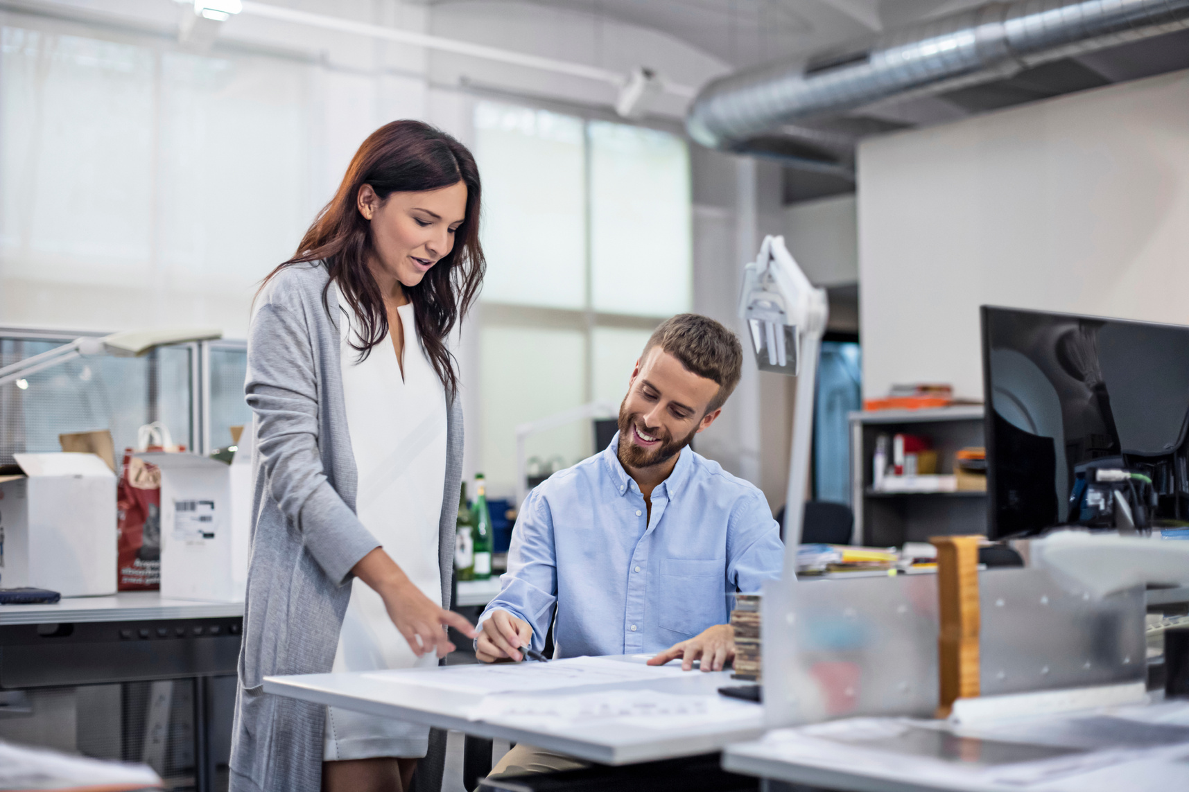 Industrial designer discussing project with coworker